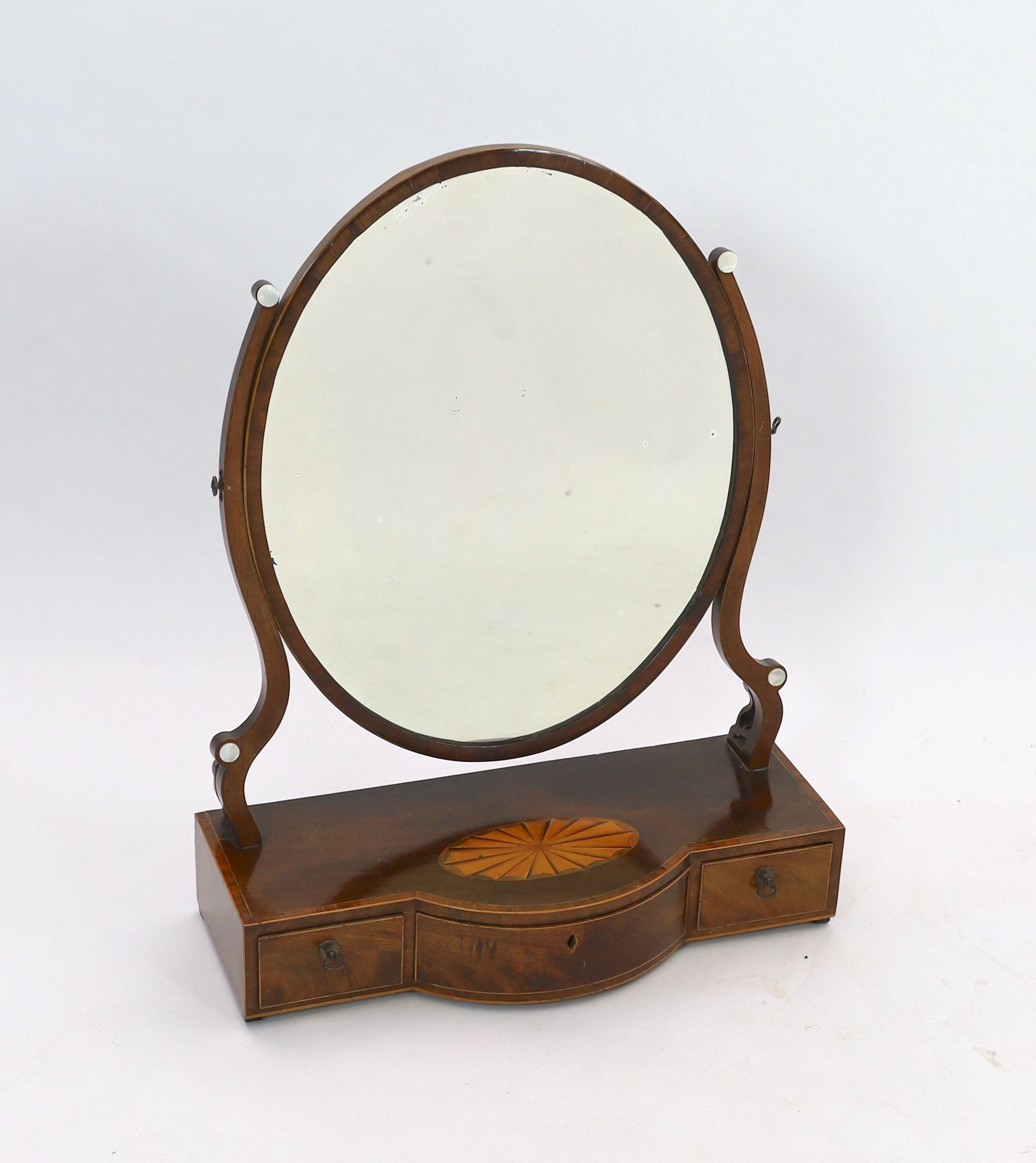 A George III mahogany satinwood paterae inlaid bowfront toilet mirror, width 57cm depth 24cm height 73cm